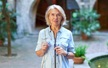 Attractive middle-aged blond woman et street.