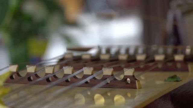 Close up shot of musician playing dulcimer in slow motion