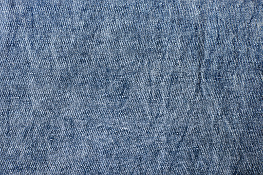 Fragment of the blue denim. Jeans background or texture.