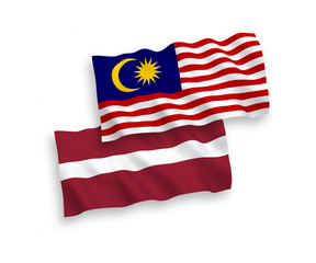 Flags of Latvia and Malaysia on a white background