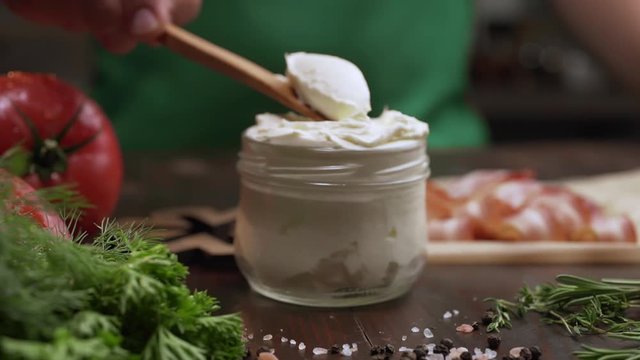 The cook takes cream cheese from glass jar by wooden spoon, cooking with cottage cheese, ingredients at the kitchen, Full HD Prores 442 HQ