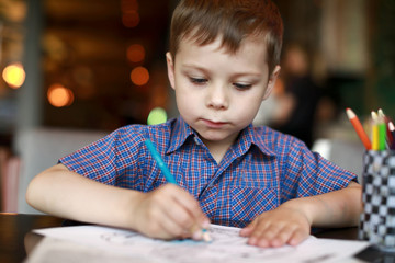 Boy drawing with pencil