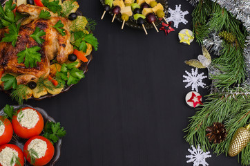 Festive New Year and Christmas table: chicken, stuffed tomatoes, canapes with copy space