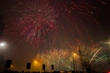 Red, green and yellow festive fireworks on a black background. Abstract holiday background. International Fireworks Festival ROSTEC