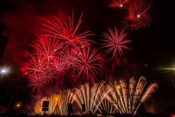 Red and yellow festive fireworks on a black background. Abstract holiday background. International Fireworks Festival ROSTEC