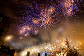 Blue and yellow festive fireworks on a black background. Abstract holiday background. International Fireworks Festival ROSTEC