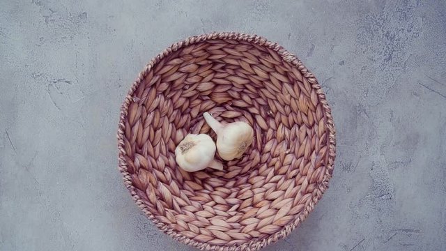 Organic garlic cloves in small basket.