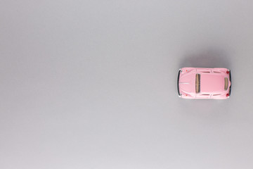 A pink car figurine, shot from above.