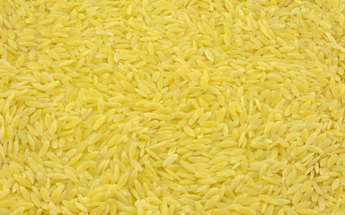 Food background of close up of raw dry orzo pasta