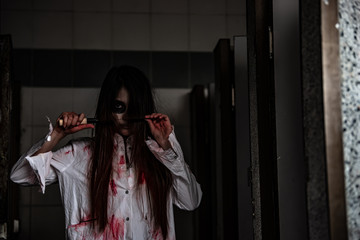 Portrait of asian woman make up ghost face with blood,Horror scene,Scary background,Halloween...