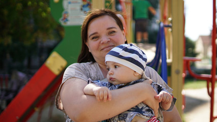 Obraz premium Plump Mother And Baby outdoors playing in Park together. Outdoor Portrait .