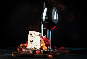 Port wine and blue cheese, still life in rustic style, vintage wooden table background, selective...
