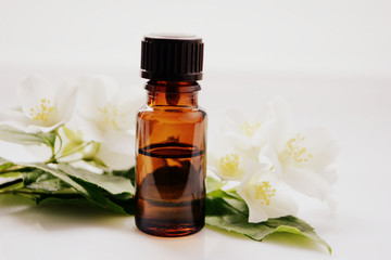 Jasmine essential oil in a glass bottle for hair and skin. Aromatherapy and Spa concept