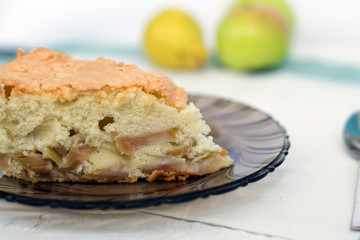 slice of apple pie. apple pie on a dark glass plate with fresh fruits on white background