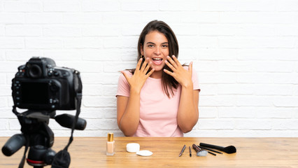 Young girl recording a video tutorial with surprise facial expression