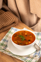 vegetarian tomato soup with olives olives pepper dill in a cup and saucer in a cafe