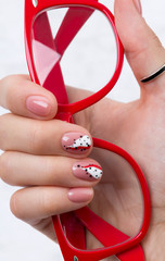 Bright fashionable abstract manicure on female hand