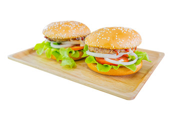 Homemade delicious Burger with meat,pork ,vegetables, spices and tomato on wooden plate a white background 