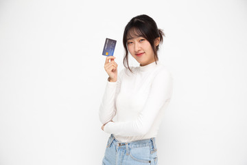 Young beautiful Asian woman smiling, showing, presenting credit card for making payment or paying online business, Pay a merchant or as a cash advance for goods, Cardholder or A person who owns a card