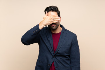 Handsome young man over isolated background covering eyes by hands. Do not want to see something