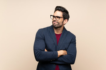 Handsome young man over isolated background making doubts gesture while lifting the shoulders