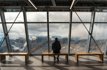 A man sitting on the observation deck on a Zugspitze mountain
