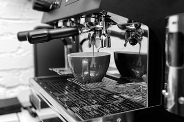 Hands of professional barista standing near the big metal coffee.