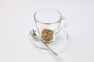 Glass cup with herbal tea on a white background