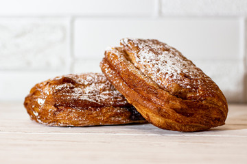 Puff bun with icing sugar on a white background.