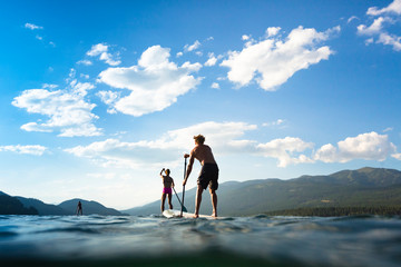 People stand up paddleboarding, Whitefish Lake, Whitefish, Glacier Country, Montana, USA.