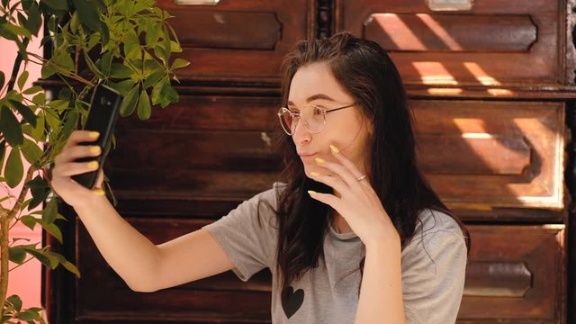 Fun selfie. Social media addiction. Woman pulling faces. Smartphone camera.