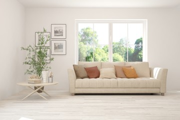 Stylish room in white color with sofa and summer landscape in window. Scandinavian interior design. 3D illustration