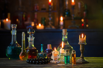 magic potions in bottles on wooden table