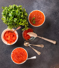Salmon  Red Caviar in a white plate on a dark background. Healthy Food Concept. Snack.Seafood.