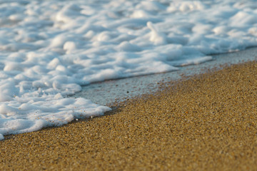 Surf of ocean. Waves of the Atlantic Ocean run onto the sandy shore. Natural fresh background for poster, banner, postcard, greeting card, touristic guide.