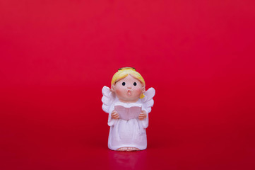 Cupid doll and heart-shaped on red background