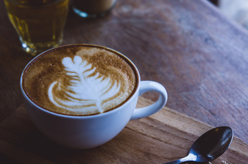 coffee hot drink cappucino latte art on wood vintage table , coffee time on wood background cafe