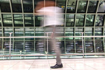 A man walking in blurred motion at airport hall. Abstract image of traveler in the lobby.