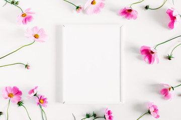 Beautiful flowers composition. Blank photo frame, pink cosmos flowers on white background. Flat...