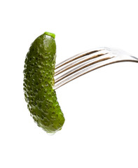 Pickled cucumber sticking on a fork isolated on white