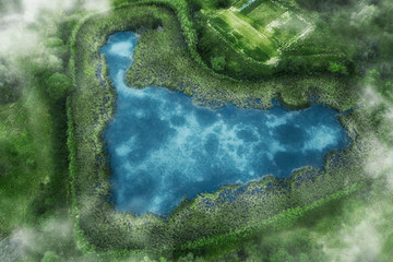 aerial view of blue lake in shape of heart. natural amazing romantic green spring summer background. drone shot.