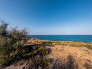 View of the beautiful San Lorenzo rock beach, in the southern Sicily, Italy. The shot is taken during a sunny summer day