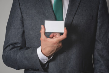 Blank name badge with a copy space in a businessman hands.