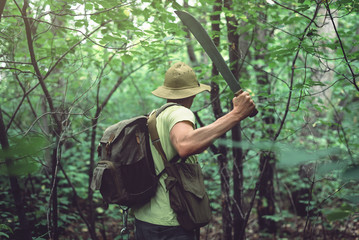 Tourist clears his way with a machete.