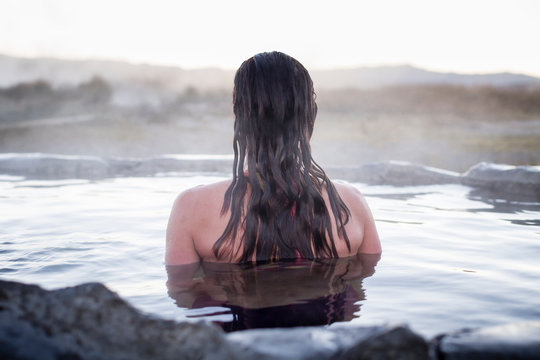 Rear view of woman in hot spring