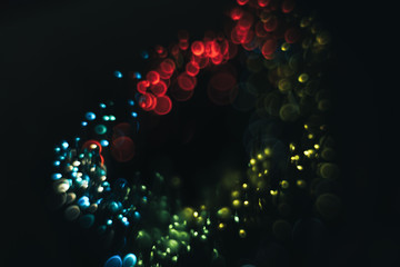 Beautiful multi colored bokeh background on a dark.