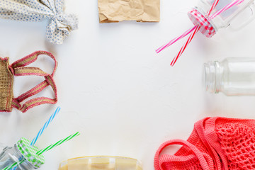 Zero waste concept: glassware, paper bag, string bag, textile bag, burlap. Flat lay, copy space.