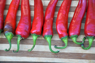Red chili peppers on the kitchen board