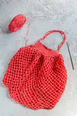 Crochet string bag on a gray background. Zero waste concept.