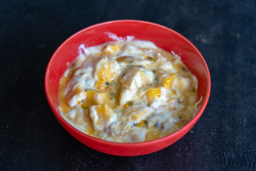 Mango, passionfruit and yogurt brulee. Fruit dessert on breakfast with wedges of perfectly ripe in season mangoes covered fresh passion fruit pulp